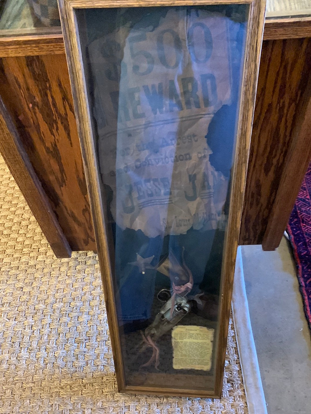 Framed reward sign with gun