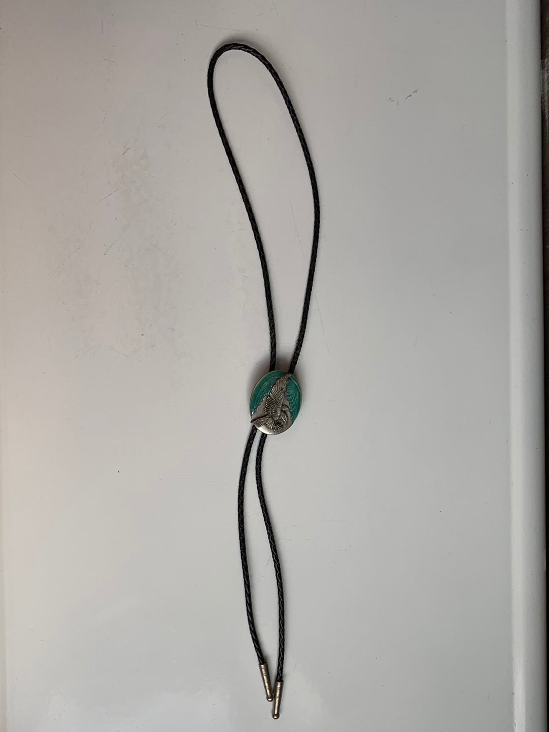 Landing eagle on turquoise enamel bolo with black leather tie