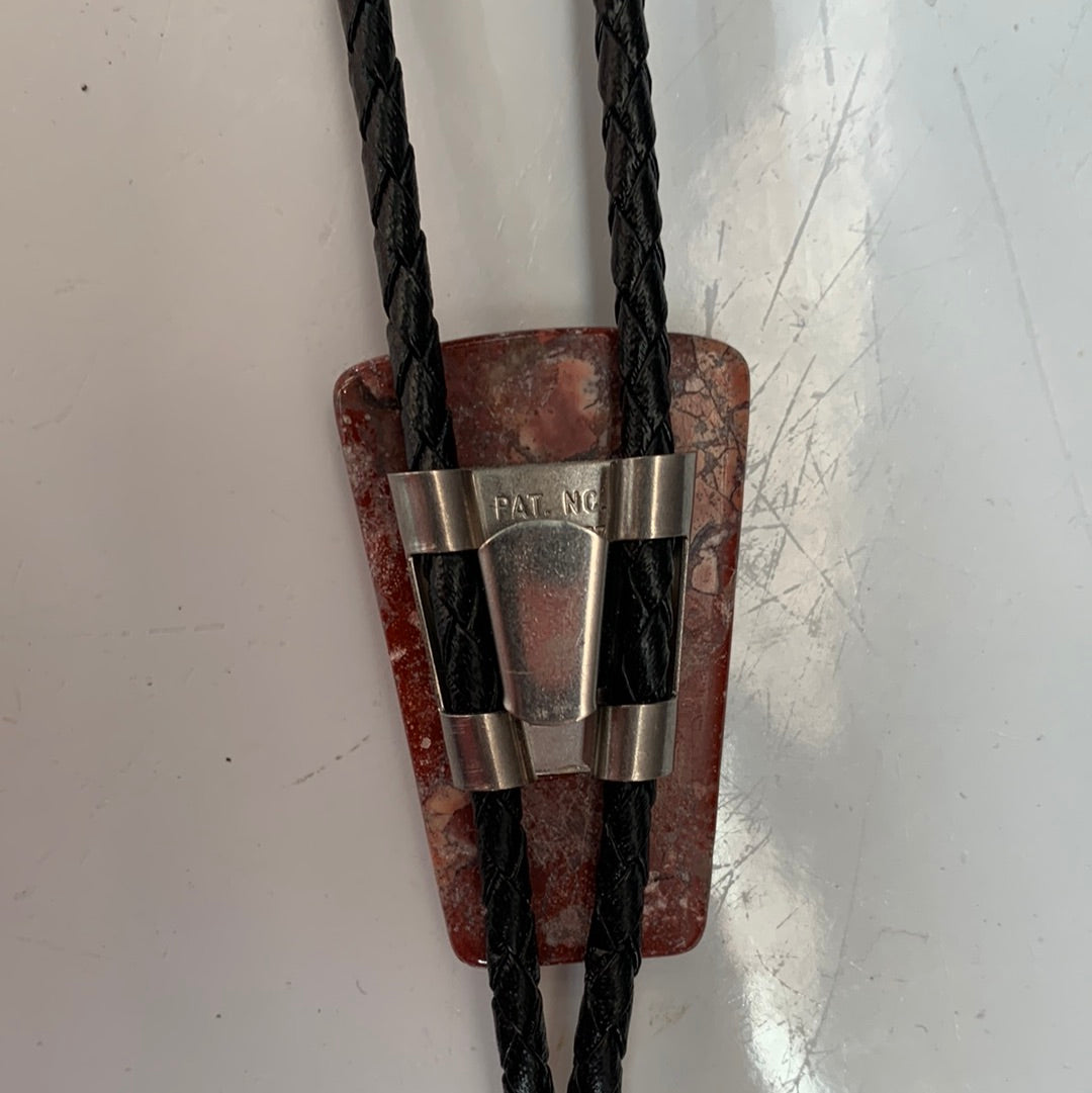 Polished red stone bolo with black leather tie