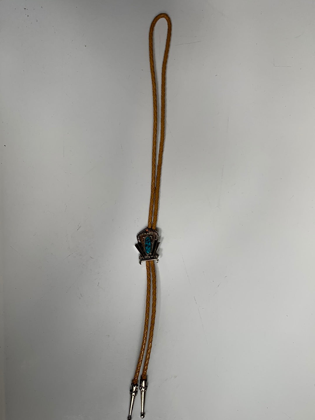 Silver decorative bolo with stone and tan leather cord