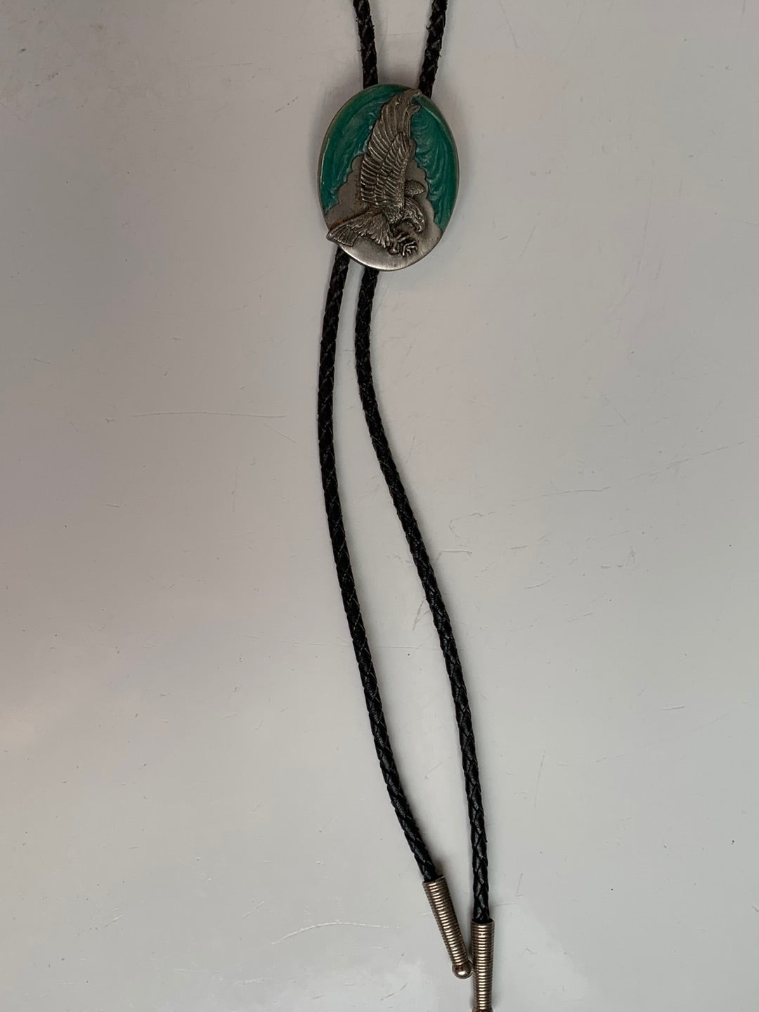 Landing eagle on turquoise enamel bolo with black leather tie