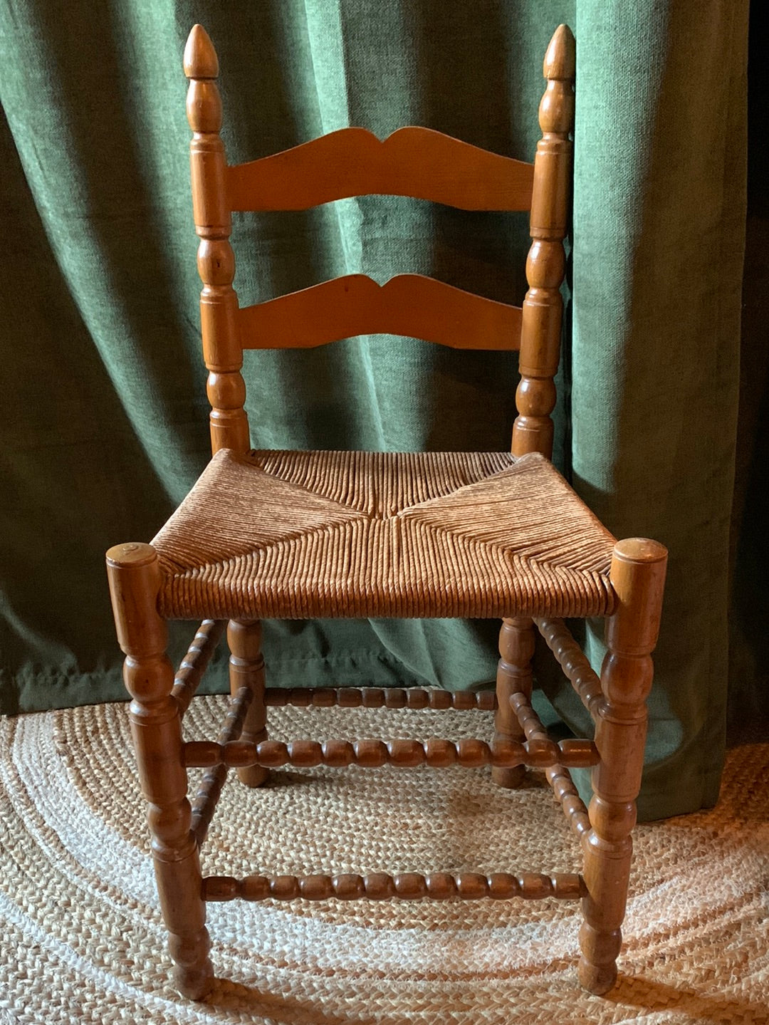 Vintage carved wood chair with wicker seat