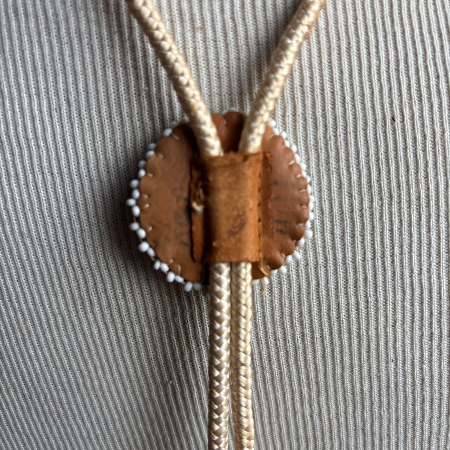 Seed Bead Thunderbird Bolo on Cream Tie