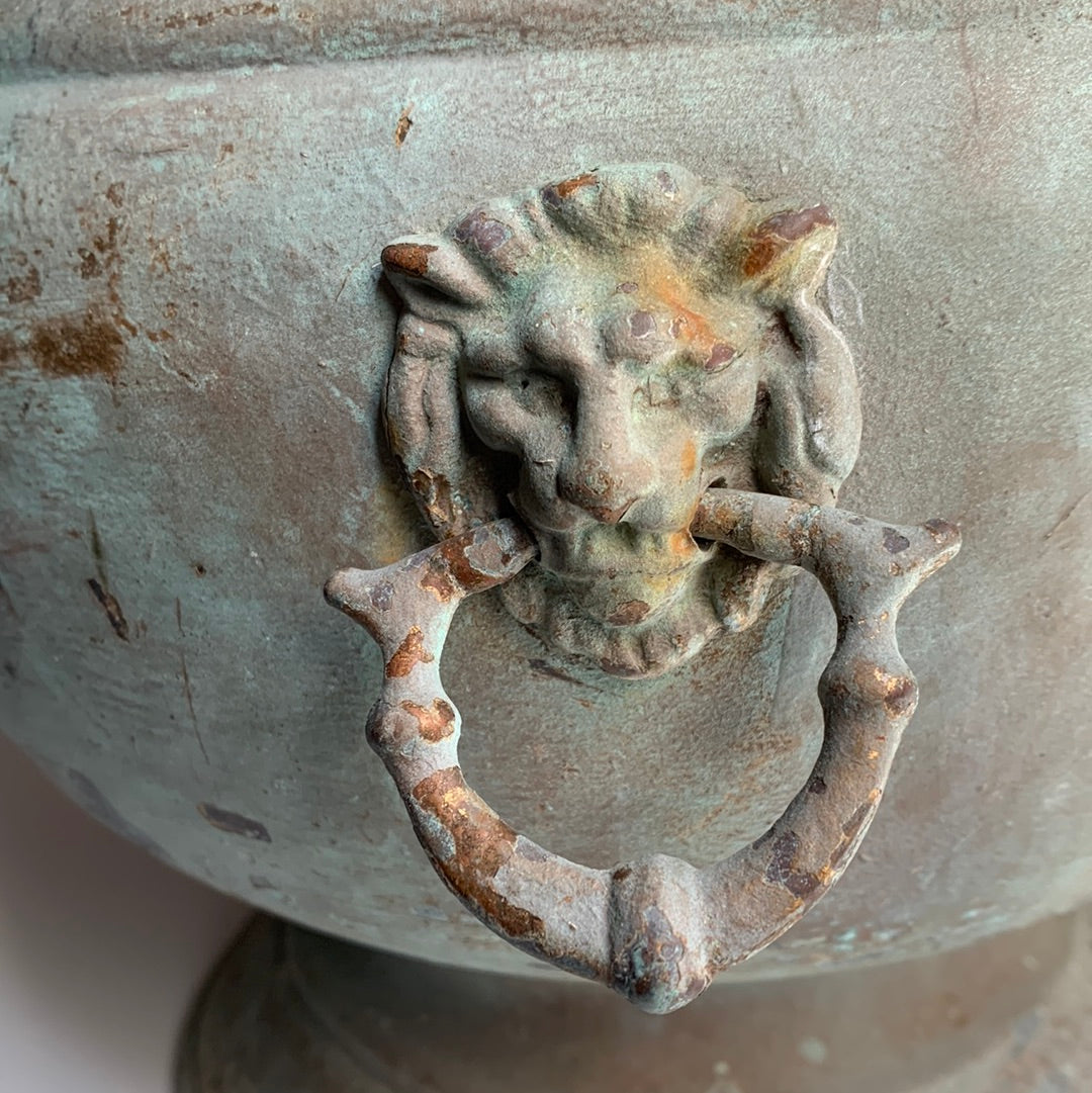 Metal planter with lion handles