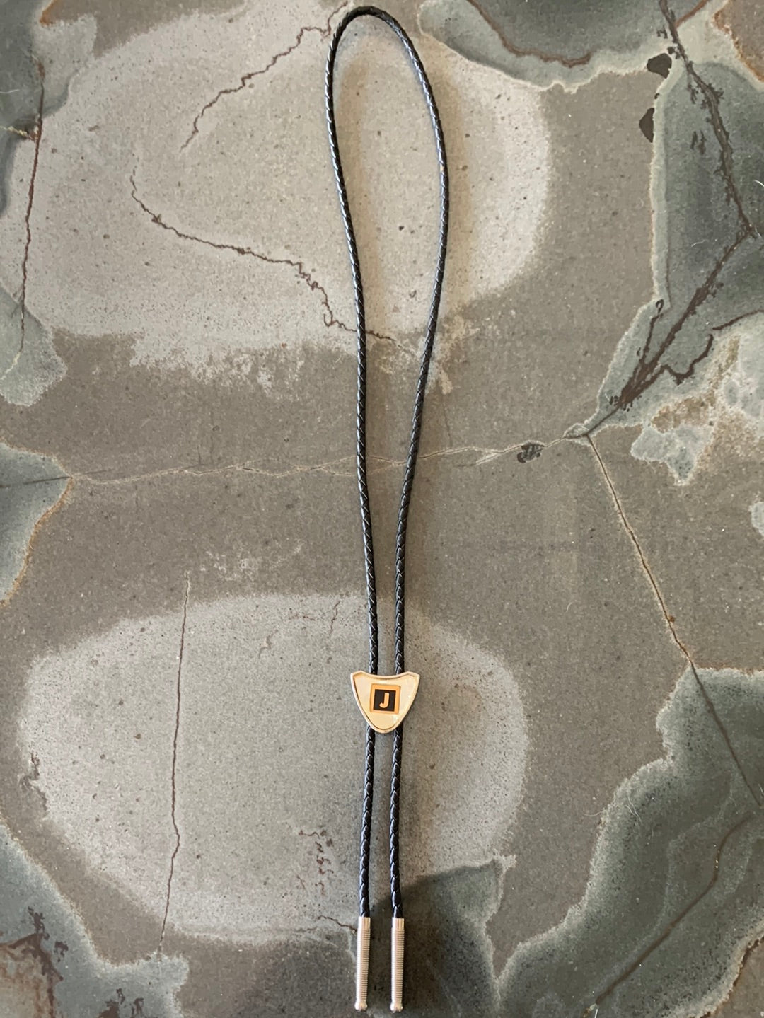 Ivory colored “J” bolo with black tie