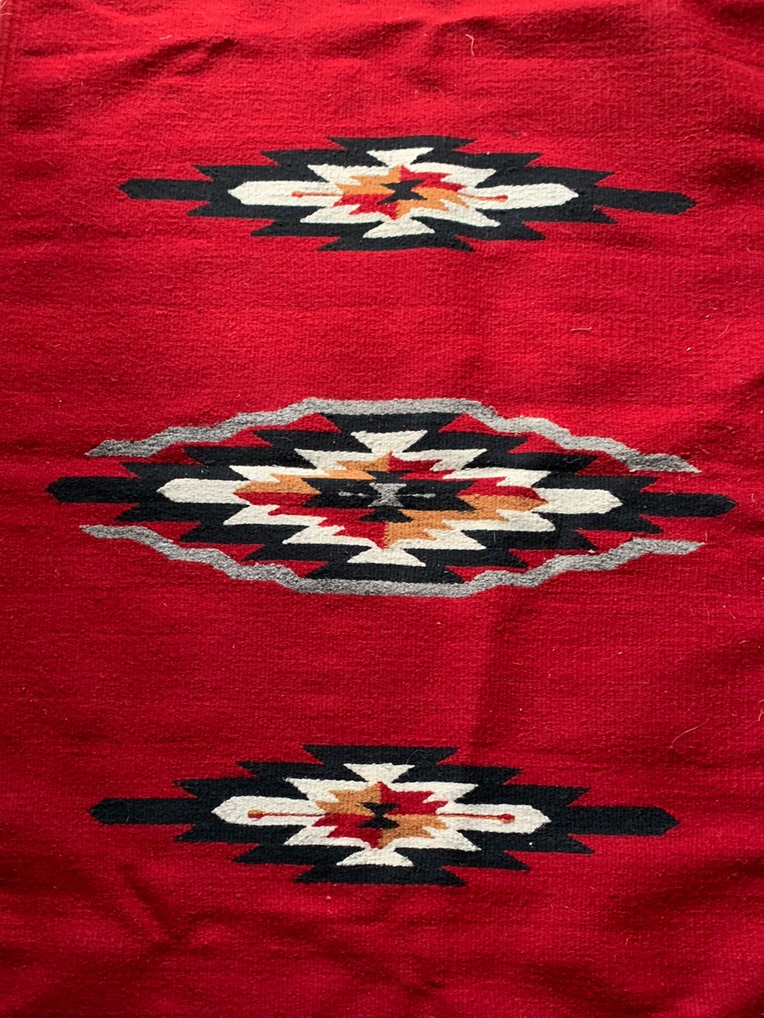 Red, black & cream woven rug with fringe