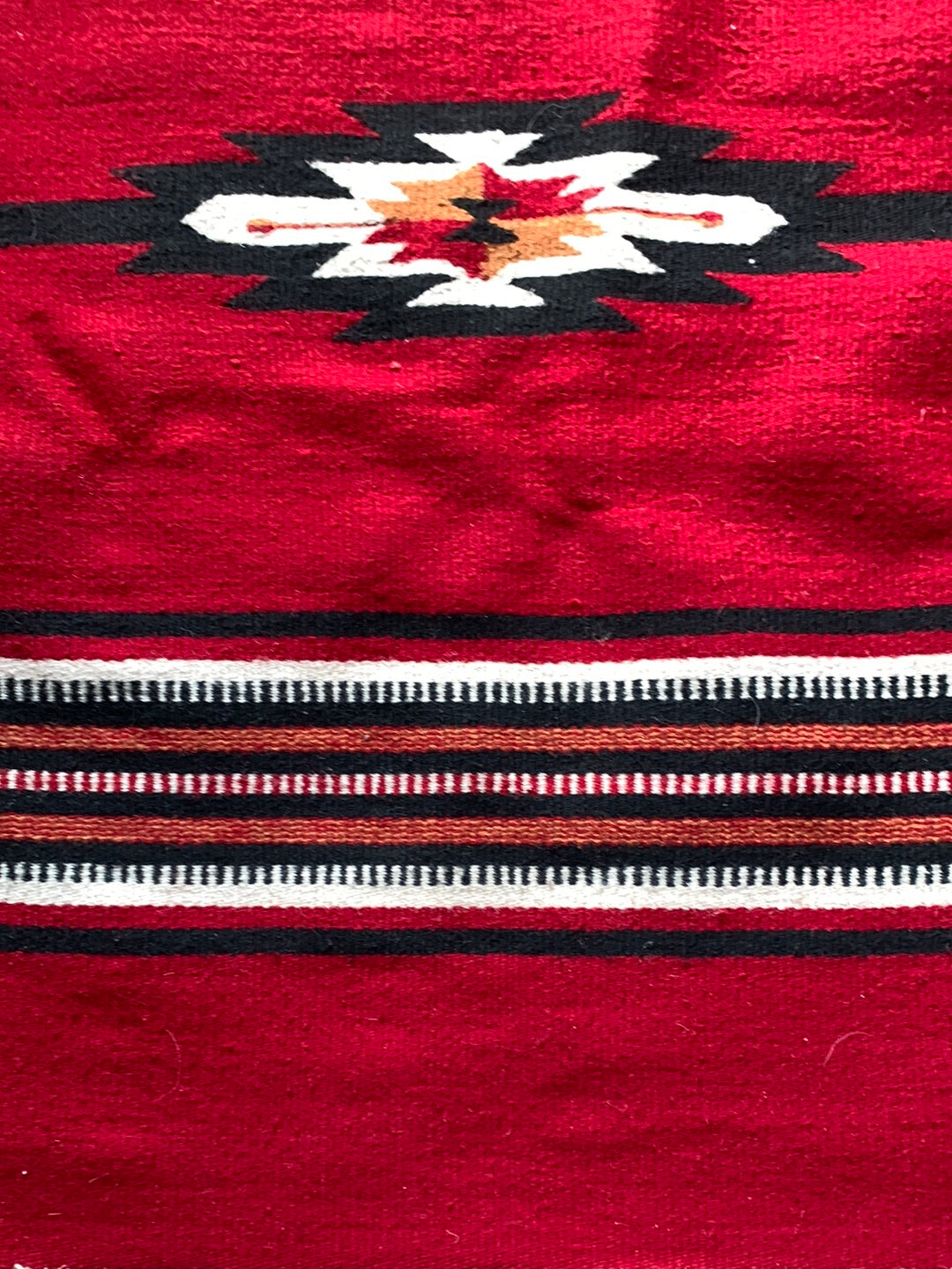 Red, black & cream woven rug with fringe