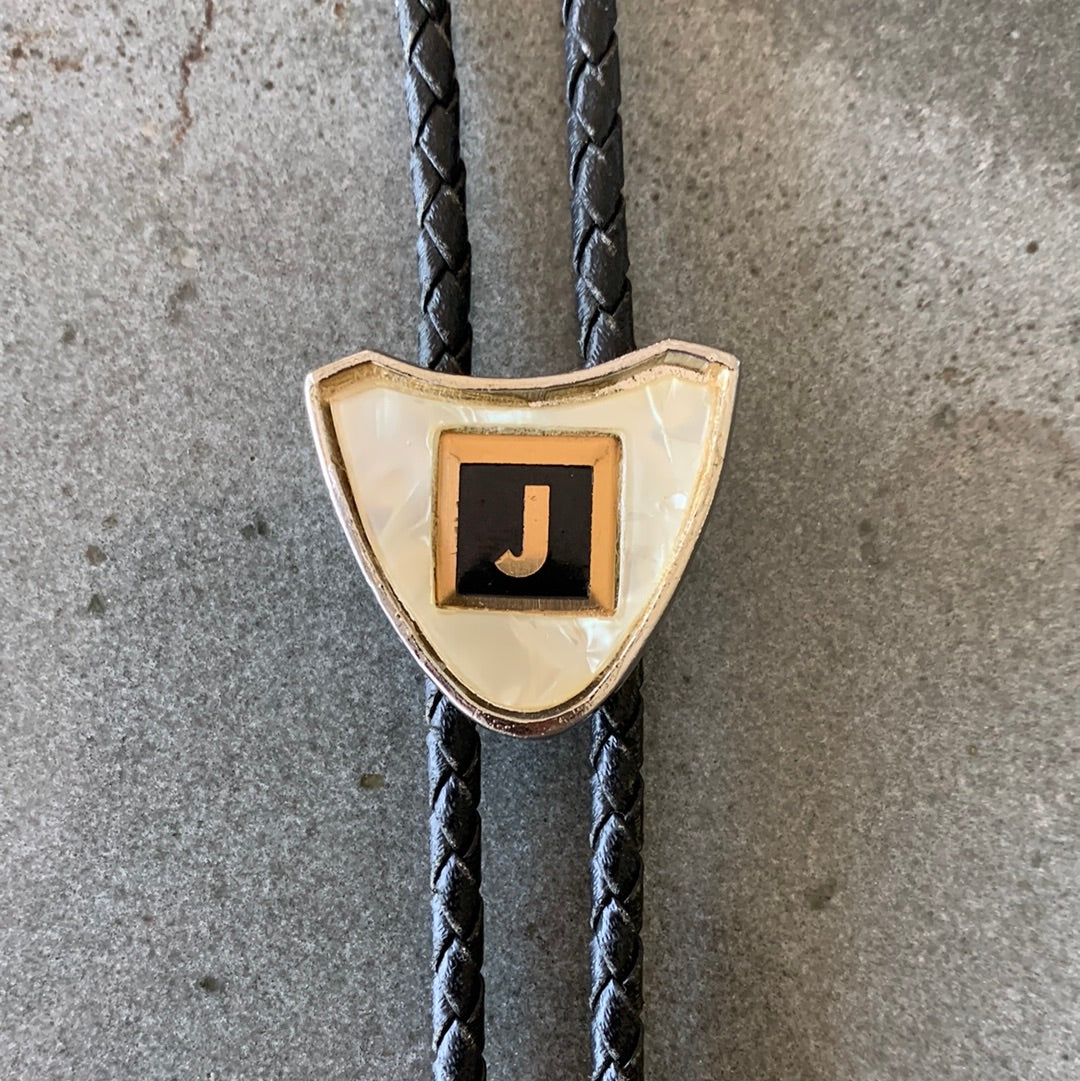 Ivory colored “J” bolo with black tie