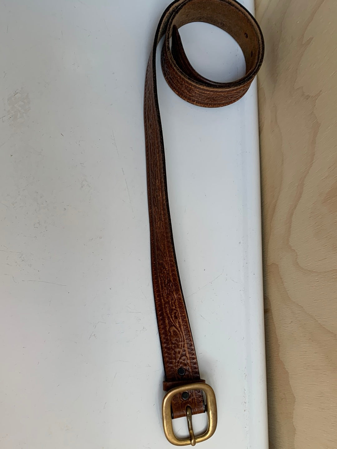 Leather belt with decorative etching