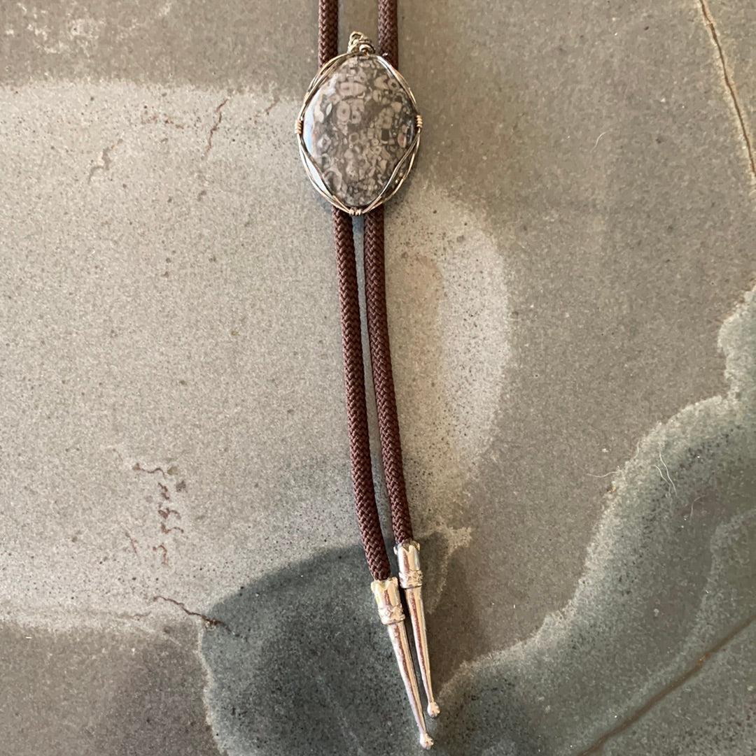 Grey silver wrapped stone bolo with brown cord