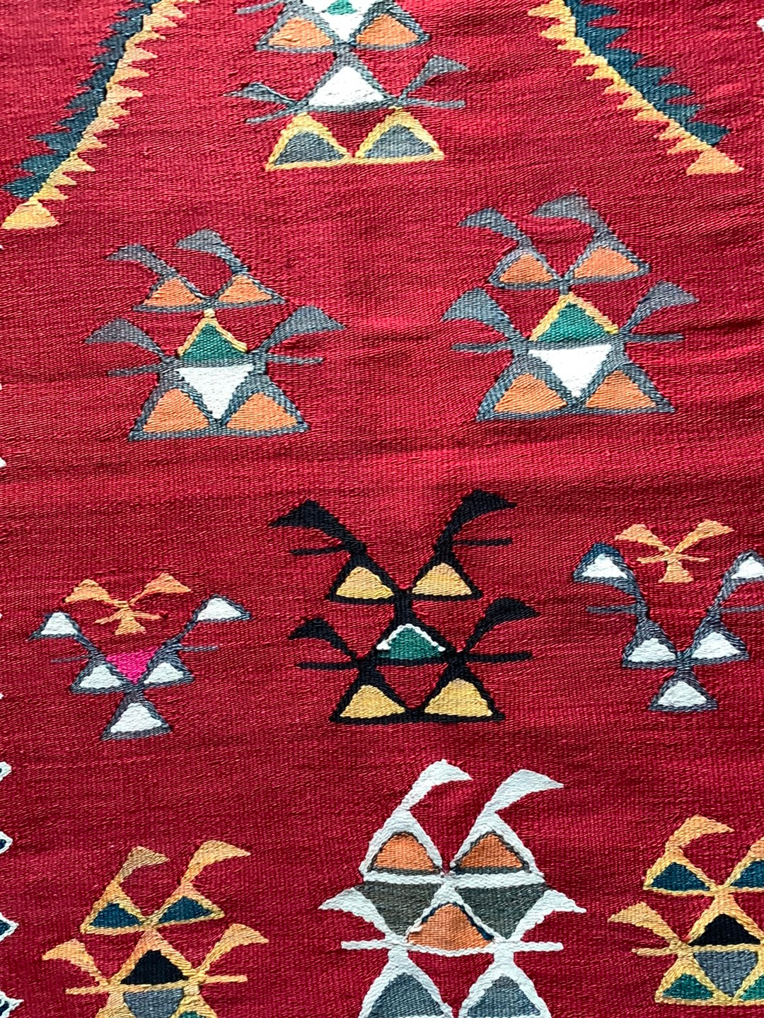 Red, yellow & teal rug with black border