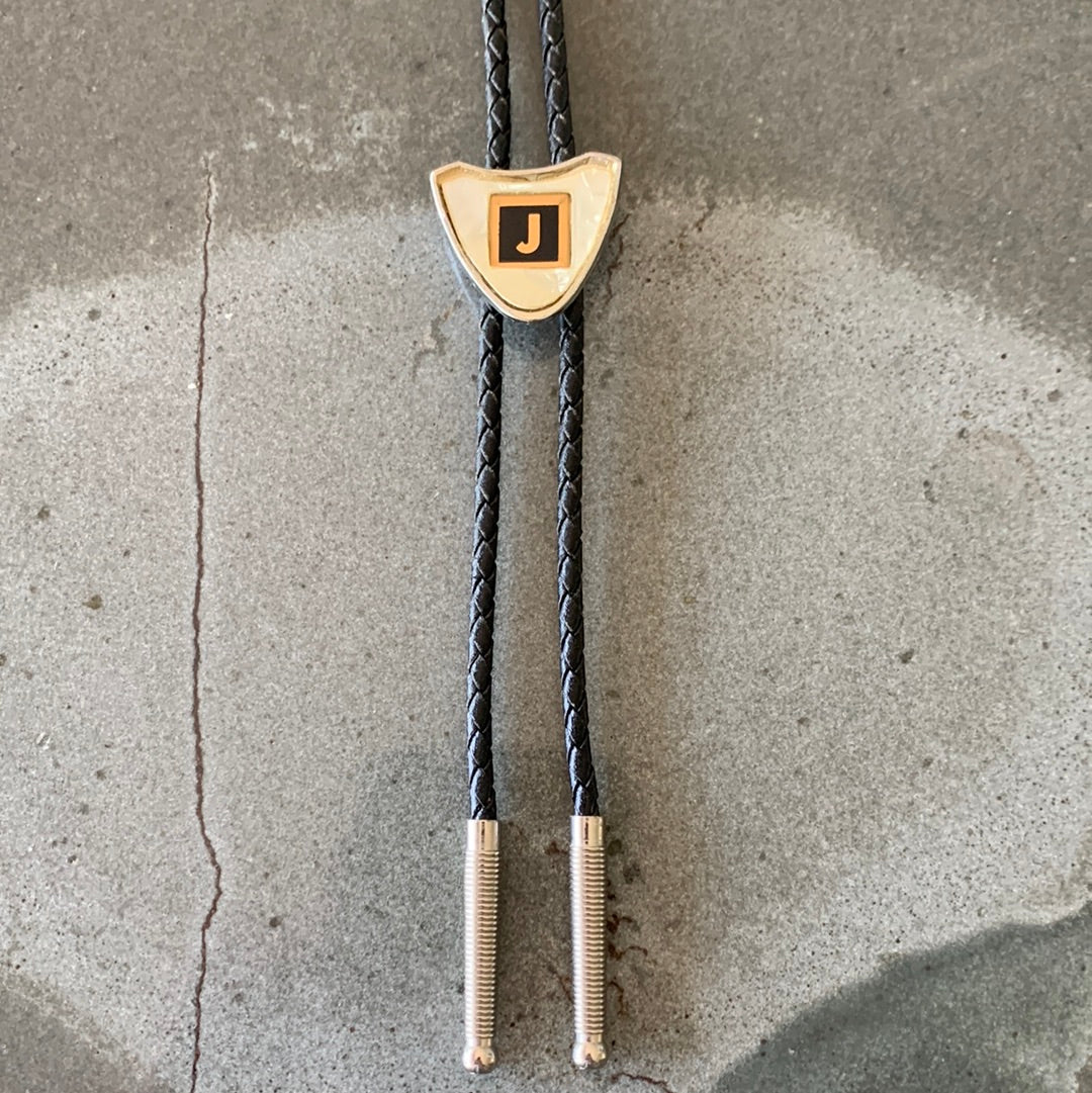 Ivory colored “J” bolo with black tie