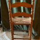 Vintage carved wood chair with wicker seat