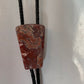 Polished red stone bolo with black leather tie