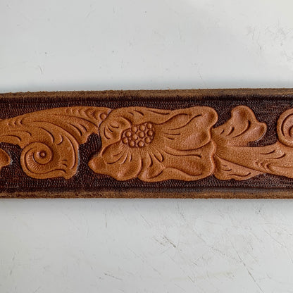 Tooled leather belt with gold buckle