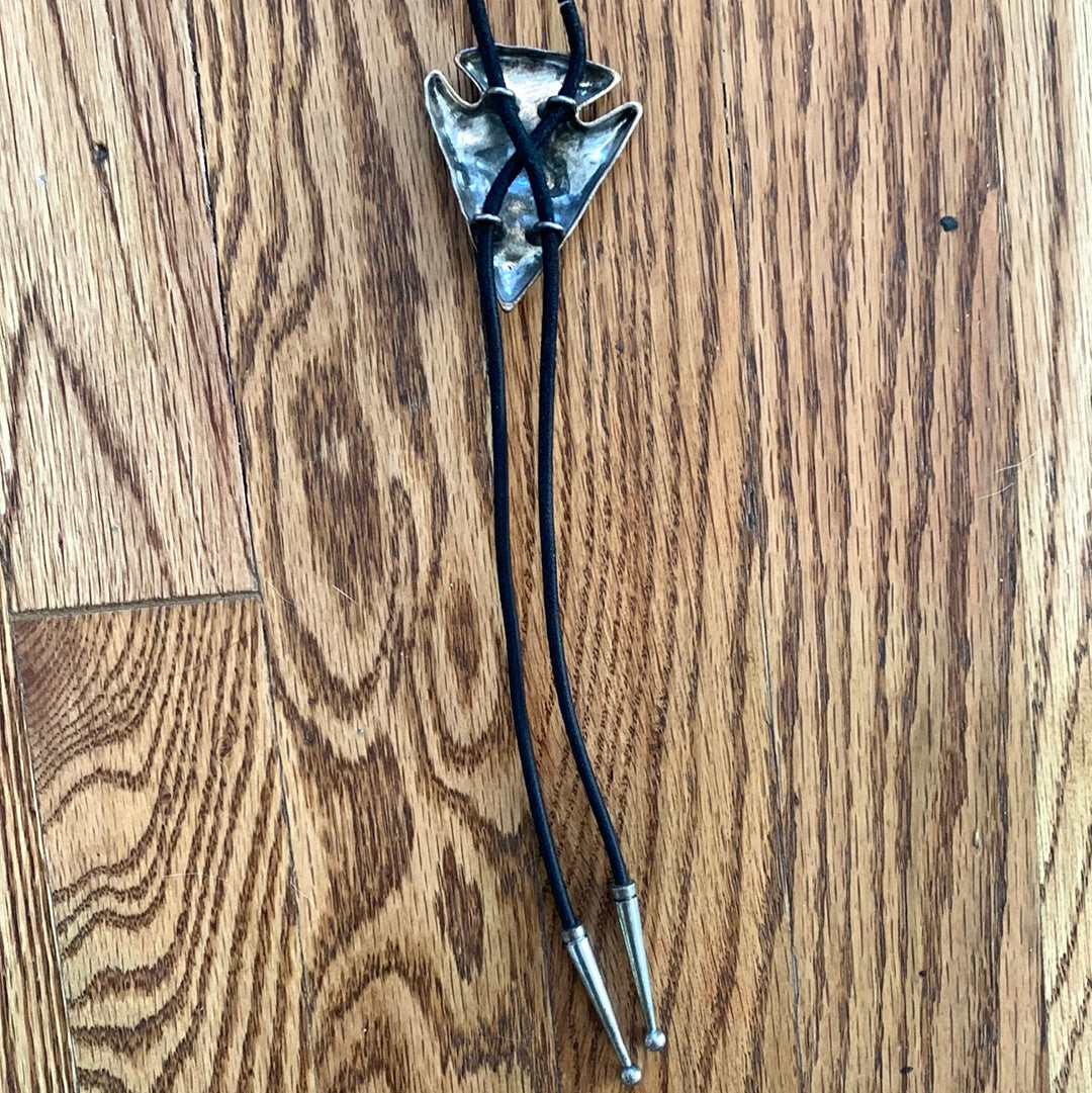 Metal arrowhead with buffalo bolo with black cord