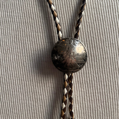 Brown and white tie with silver coin bolo