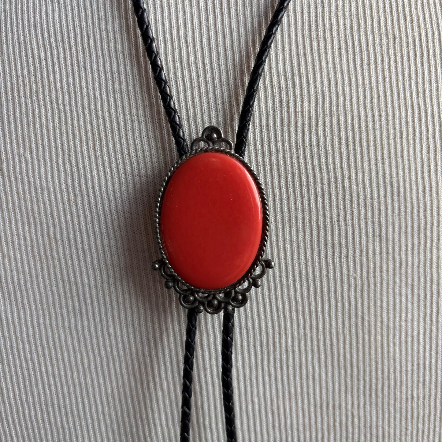 Red Oval Stone Bolo on Black Tie