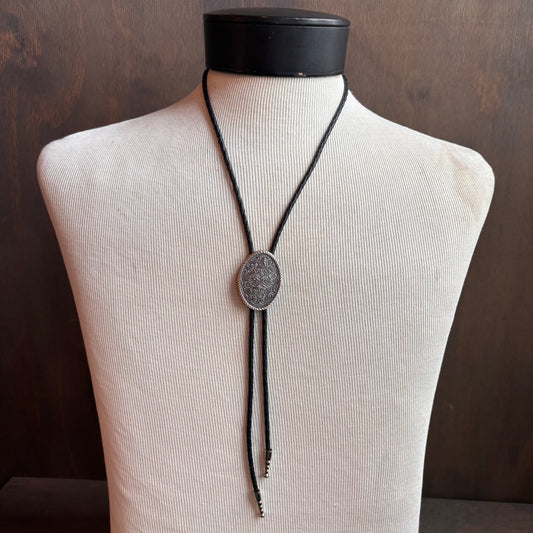Etched Oval Bolo on Black Leather Tie