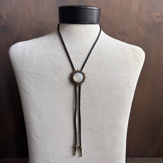 Metal Sunburst Bolo on Black Tie