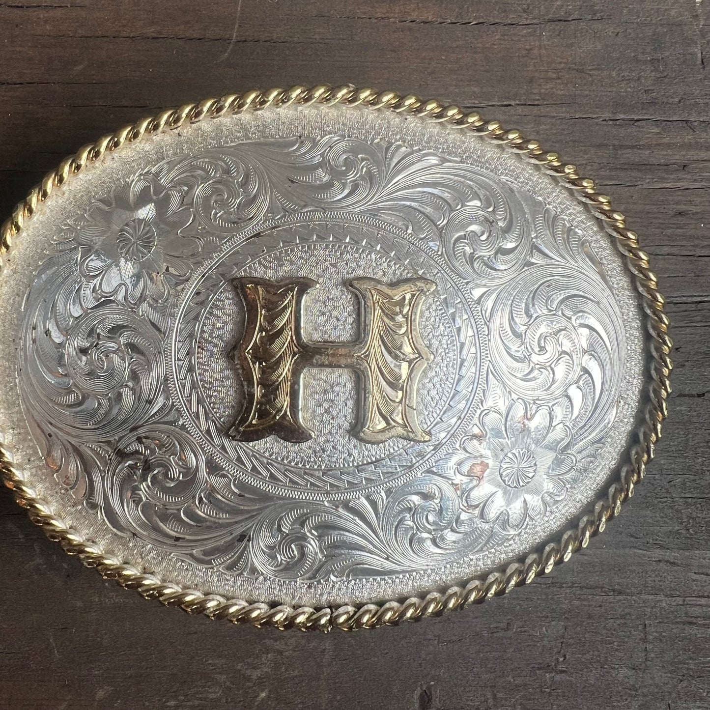 Silver Belt Buckle with Gold “H”