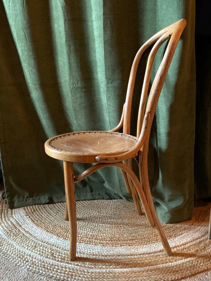 Vintage wood chair with tooled leather buck on seat