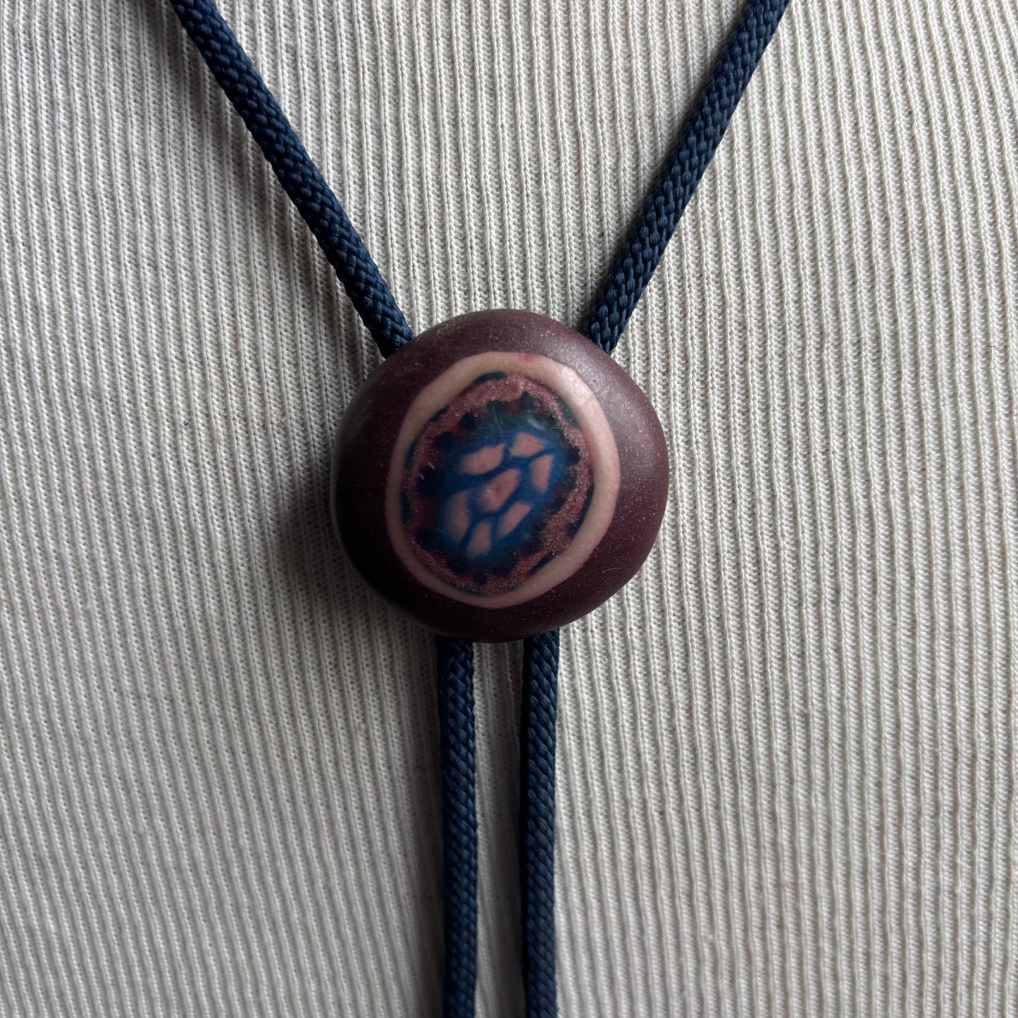 Clay Circle Bolo on Blue Tie
