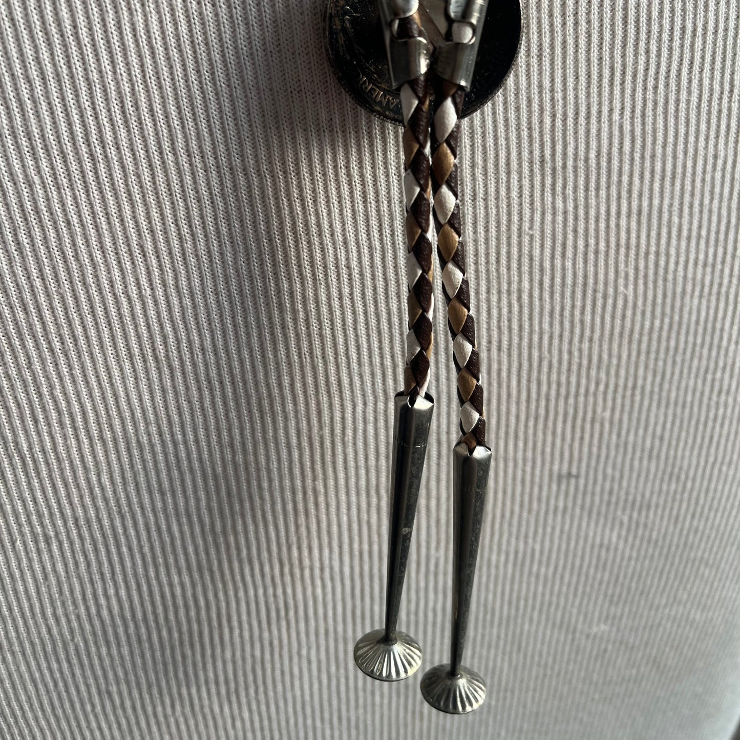 Brown and white tie with silver coin bolo