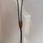 Polished red stone bolo with black leather tie